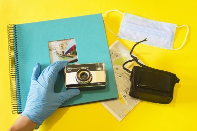 photo album and camera being held by a gloved hand